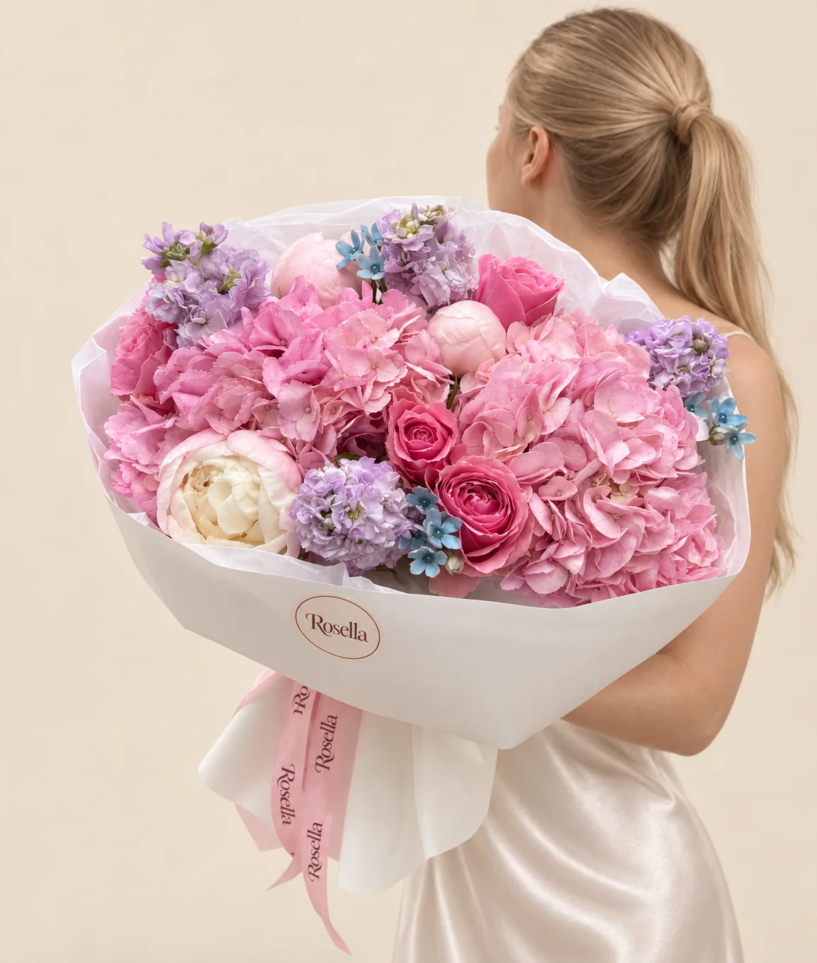 2 hydrangeas, 4 stocks, 3 blush peonies, 4 roses, 1 pink peony & 12 tweedia blooms in a hand-tied bouquet