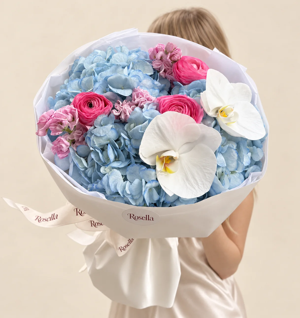 3 hydrangeas, 2 stocks, 3 ranunculus & 2 orchid blooms in a hand-tied bouquet