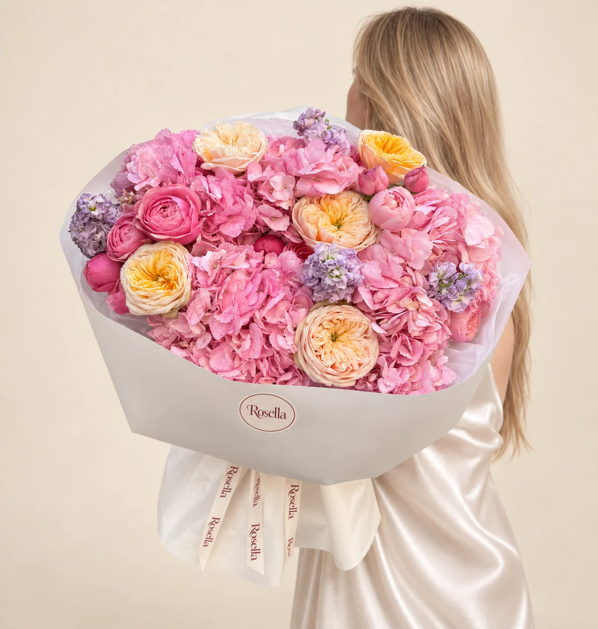 6 hydrangeas, 4 stocks, 13 spray roses, 3 cream garden roses & 2 yellow garden roses in a hand-tied bouquet