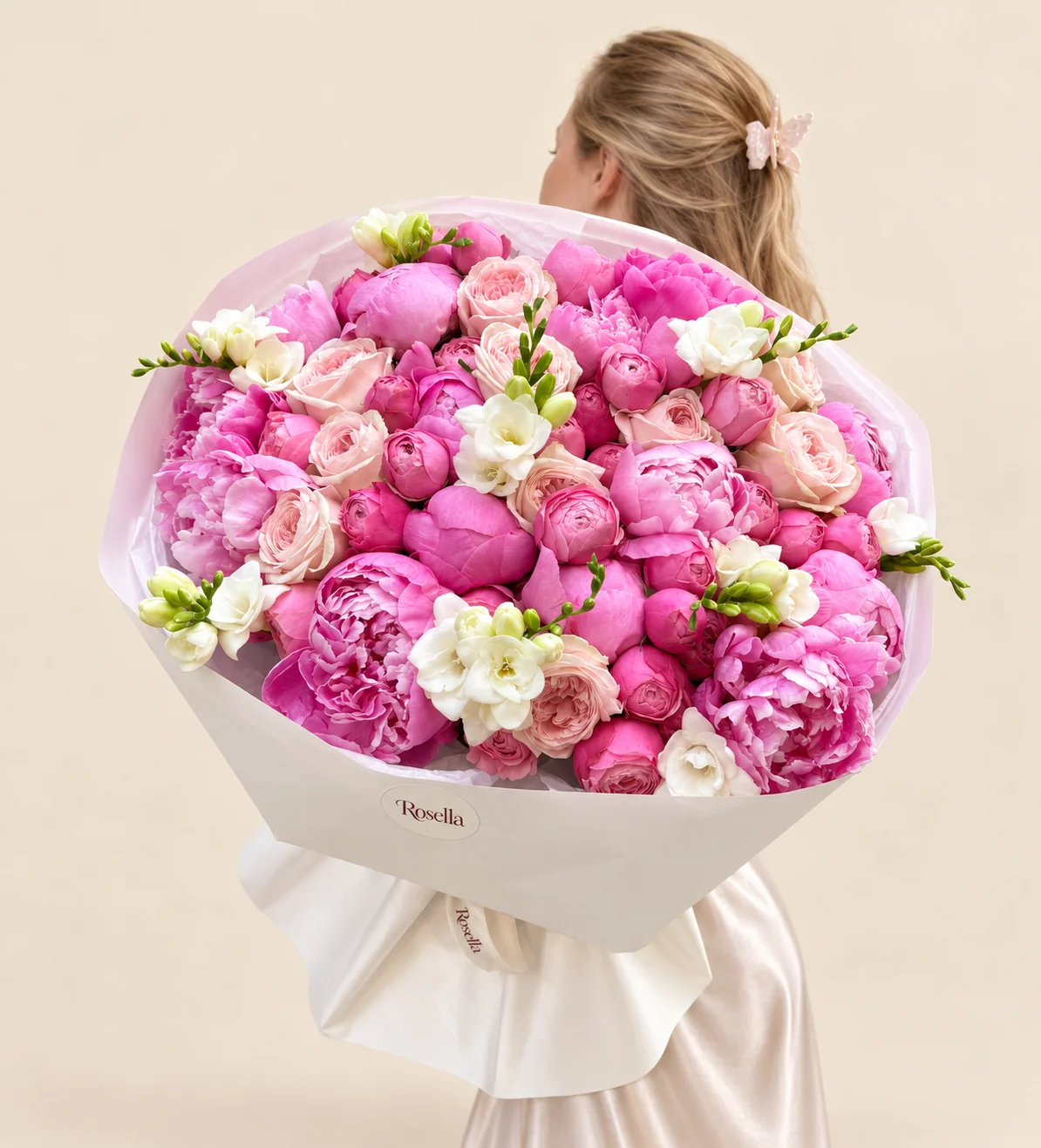 23 peonies, 12 garden roses, 25 spray roses, 6 freesias & 1 rose in a hand-tied bouquet