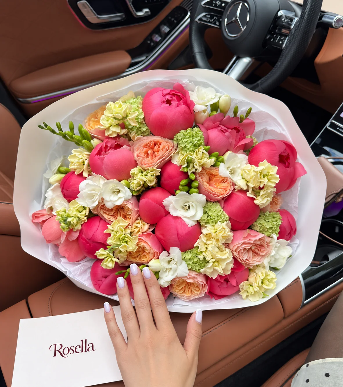 15 pink peonies, 9 garden roses, 4 stocks, 4 freesias & 1 coral peony in a hand-tied bouquet