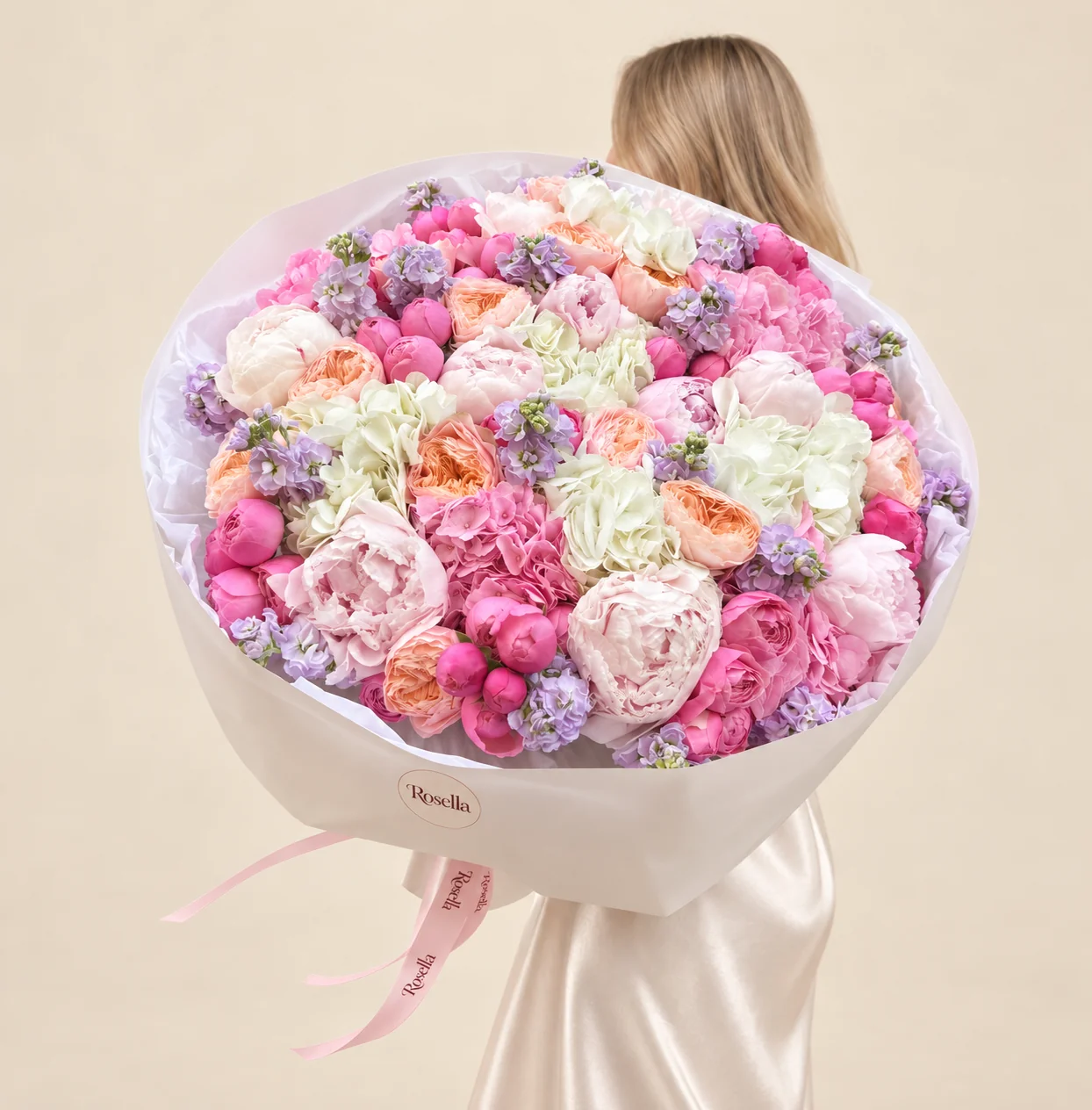 28 pink peonies, 6 white hydrangeas, 11 ivory peonies, 13 peach garden roses, 10 pink garden roses, 9 stocks & 3 pink hydrangeas in a hand-tied bouquet