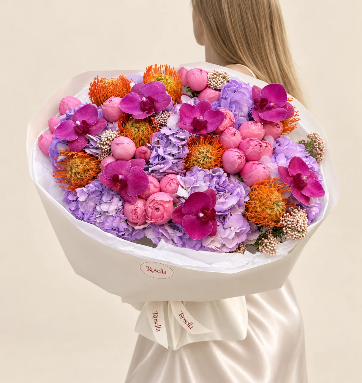 24 peonies, 7 hydrangeas, 8 orange leucospermum (pincushion protea) & 7 orchid blooms in a hand-tied bouquet