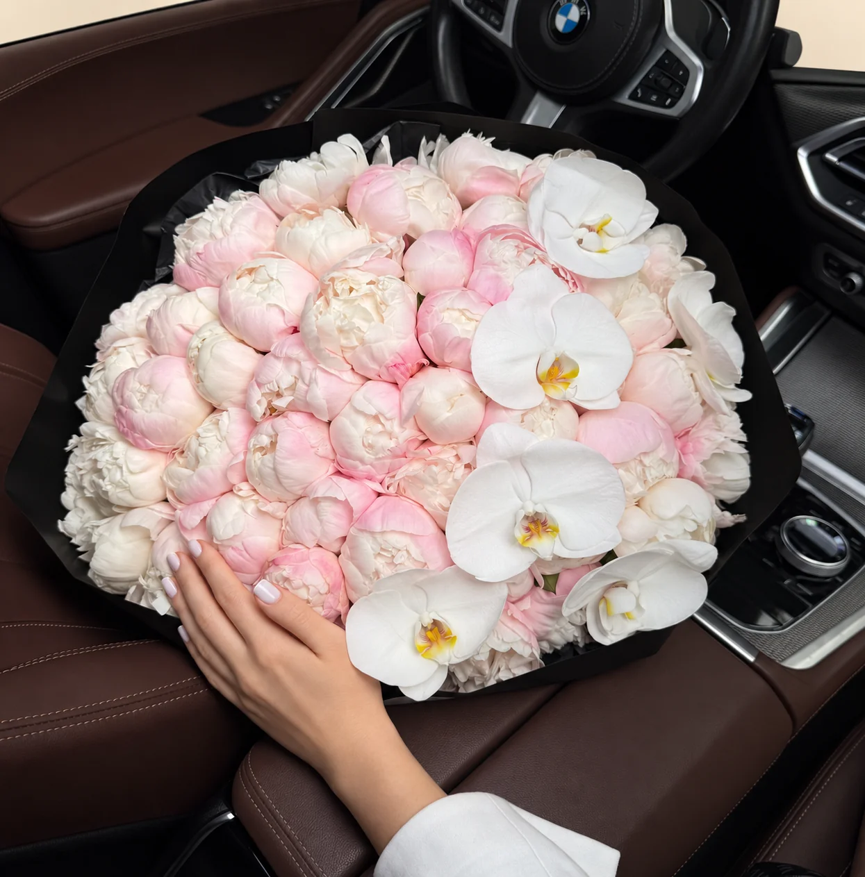 39 blush peonies, 14 ivory peonies & 6 orchid blooms in a hand-tied bouquet
