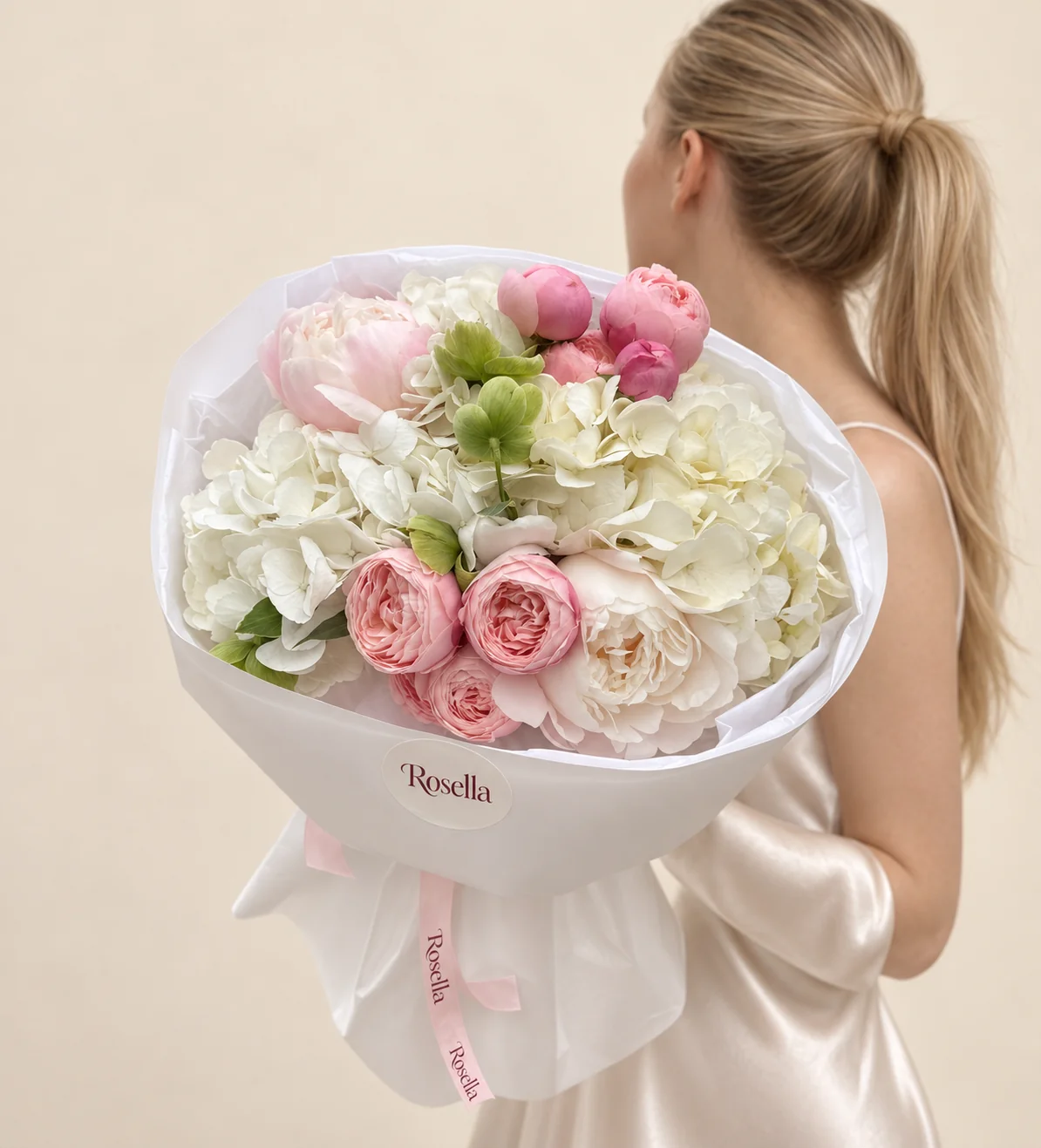 4 hydrangeas, 5 garden roses, 4 pink peonies, 1 blush peony, 1 ivory peony & 4 green hellebore in a hand-tied bouquet
