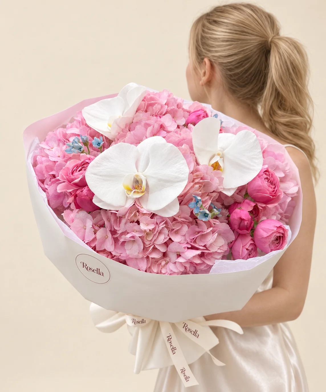 5 hydrangeas, 10 spray roses, 3 orchid blooms & 10 tweedia blooms in a hand-tied bouquet