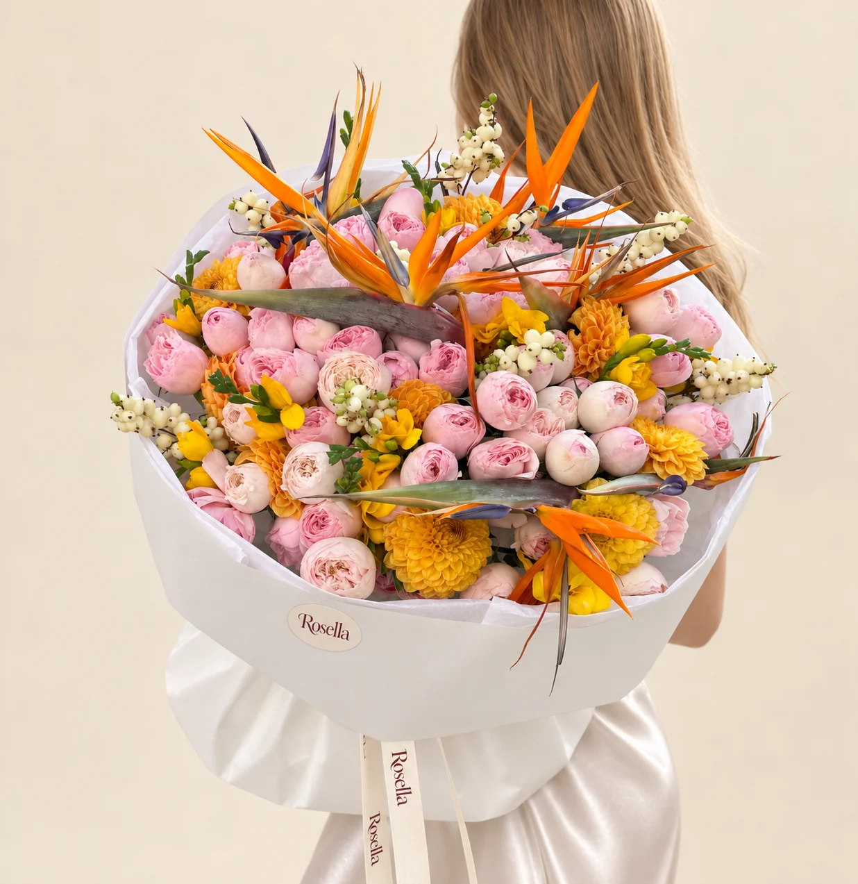 60 spray roses, 11 dahlias, 6 bird of paradise (strelitzia) & 9 freesias in a hand-tied bouquet